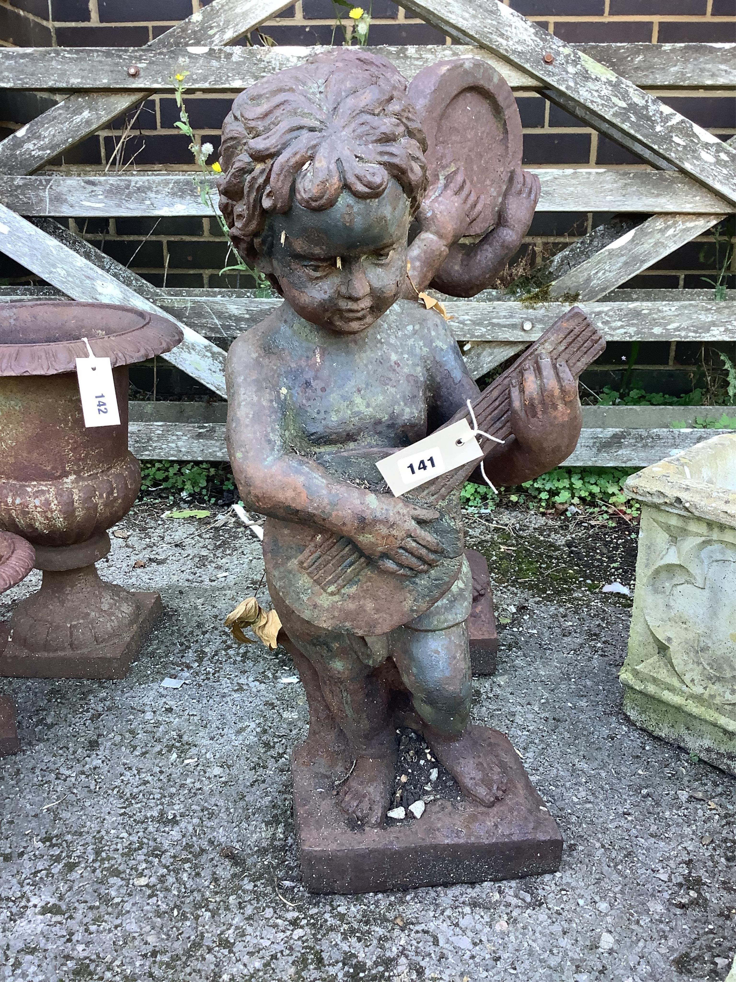 A pair of cast iron musical putti garden ornaments, larger height 68cm. Condition - fair